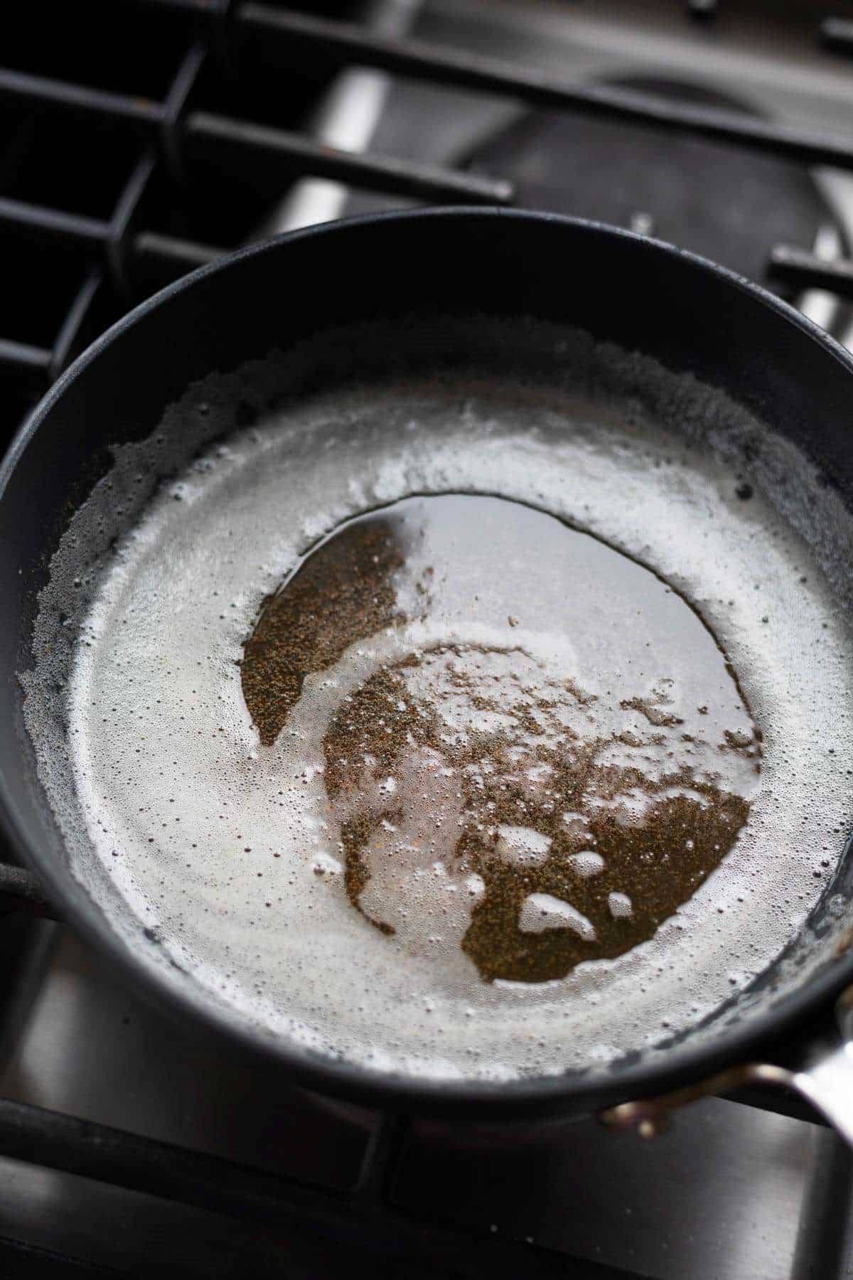 Browned butter in a black pan.