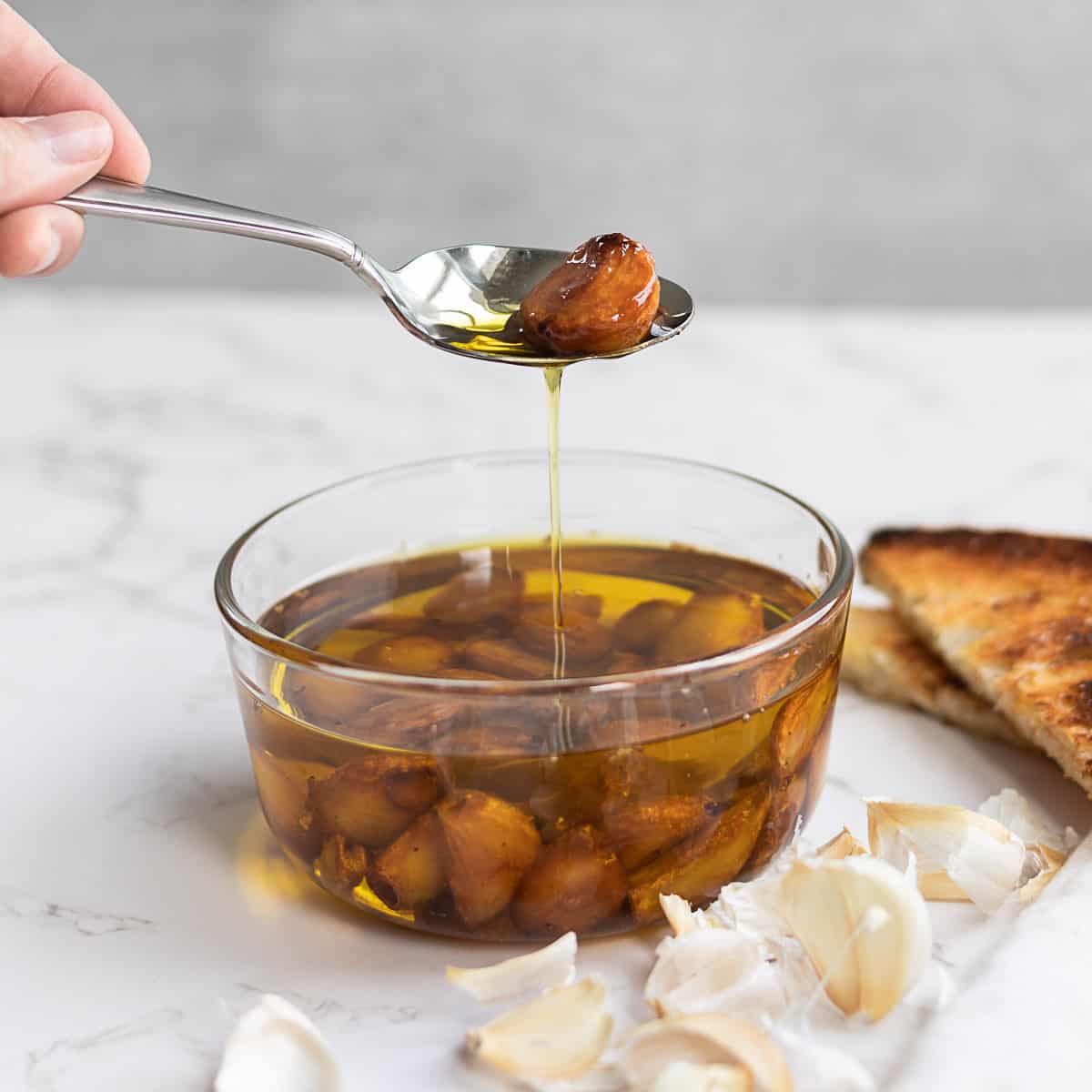 spoon holding a piece of garlic confit