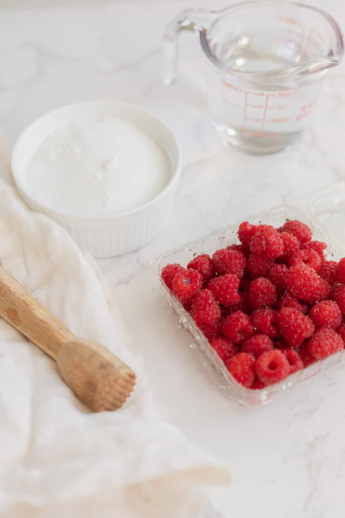 ingredients for raspberry simple syrup: sugar, water, and raspberries