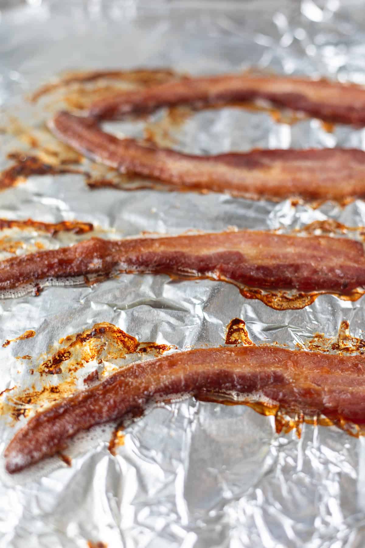 four slices of crispy bacon on foil