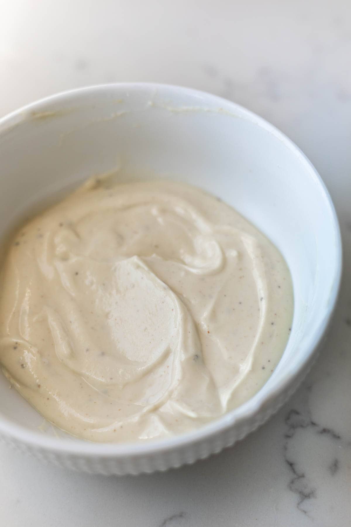 potato salad Greek yogurt dressing in a white bowl