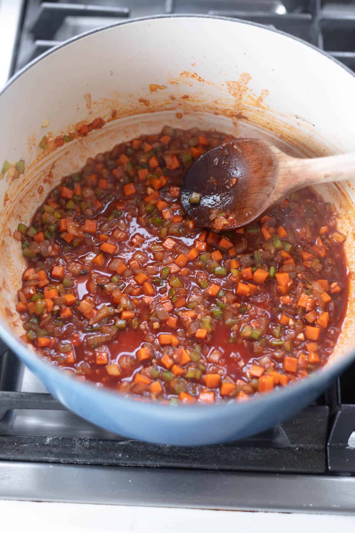 celery, carrots, and onions cooking in red wine and tomato paste