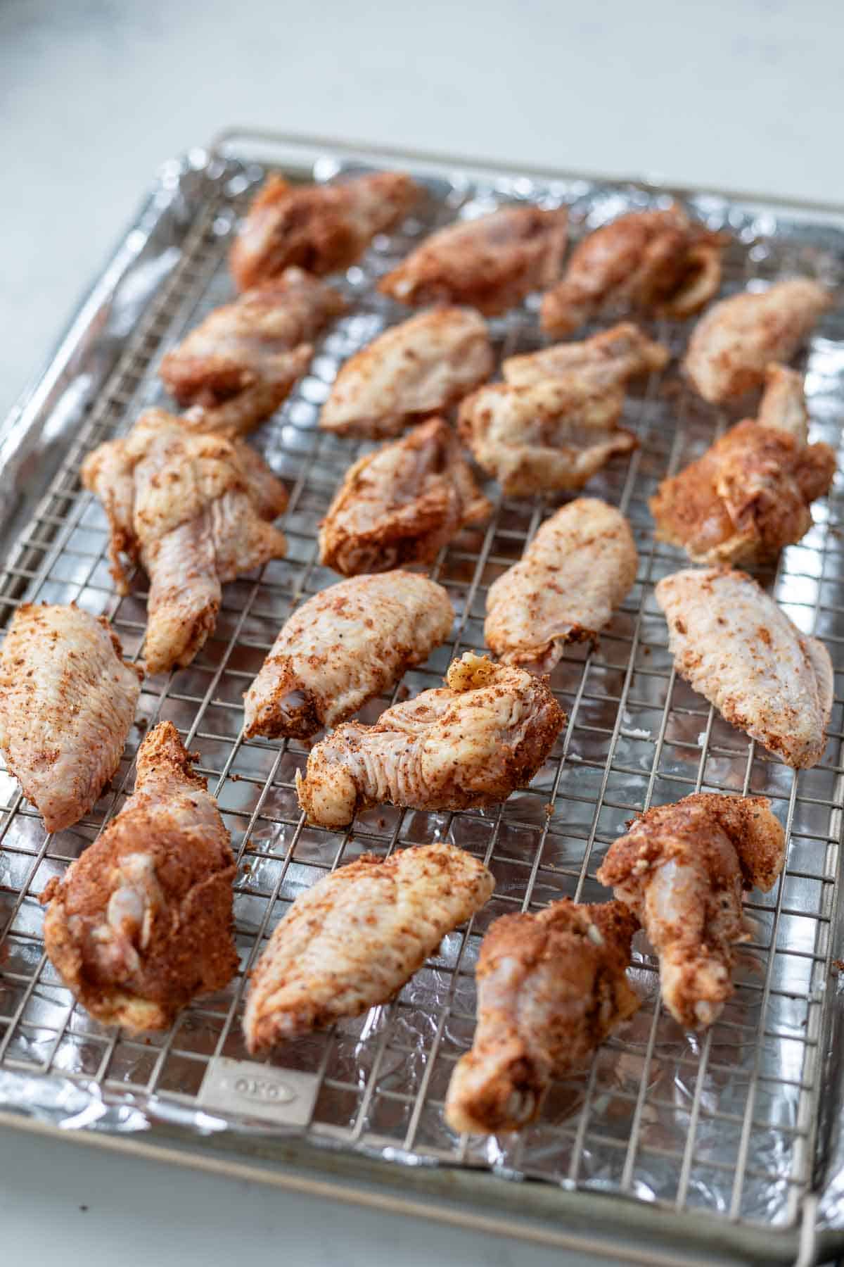Dry Rub wings on a baking rack uncooked.