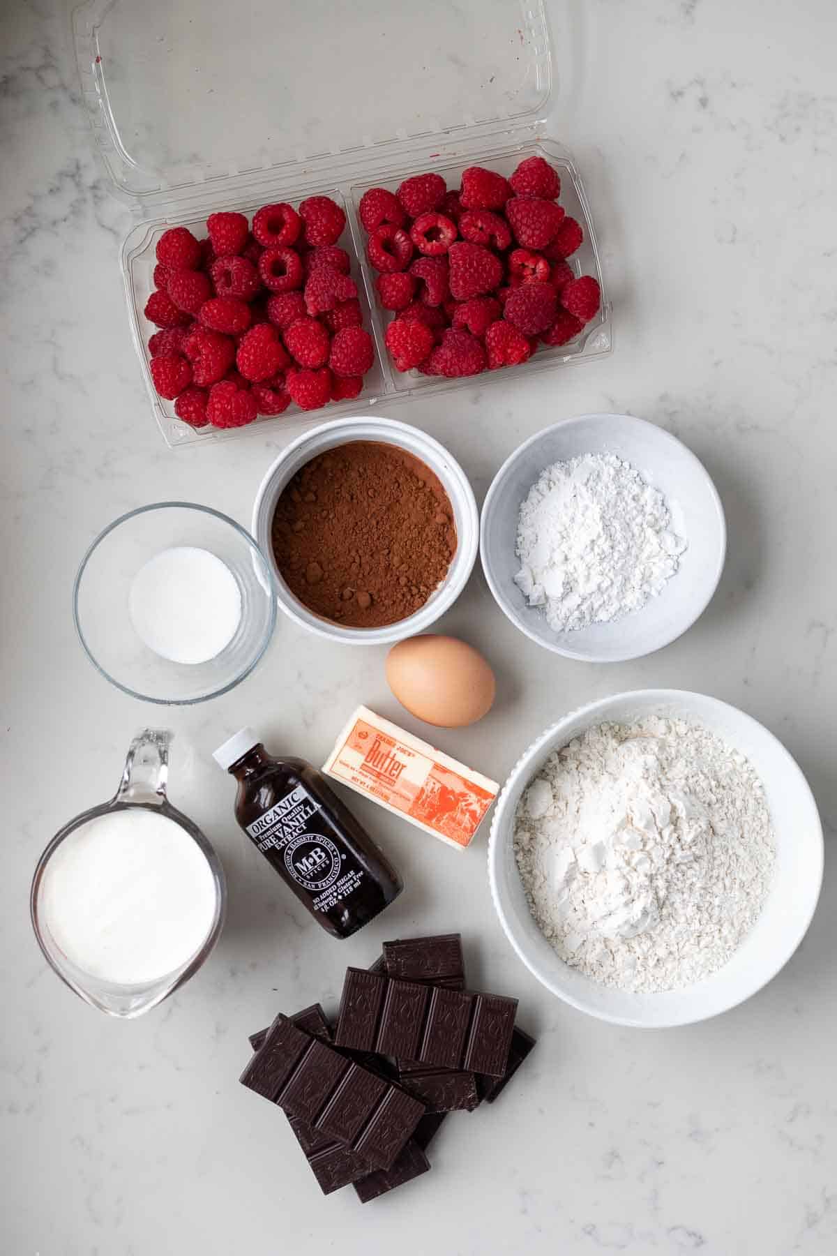 Chocolate raspberry tart ingredients on a white counter.